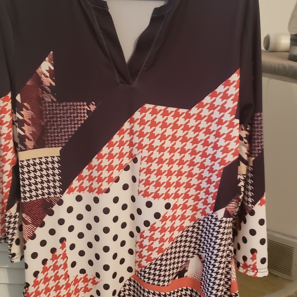 3/4 length sleeves, 30 inches from shoulder to hem. 95% polyester 5% stretch.